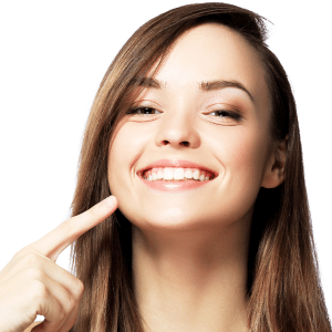 Young woman pointing at perfect smile from smile makeover procedures with Dr. Reagan Smith