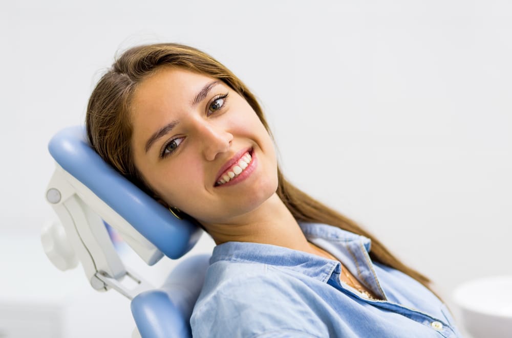 Smiling female undergoing Oral Cancer Screening at Oak Hills Dentistry