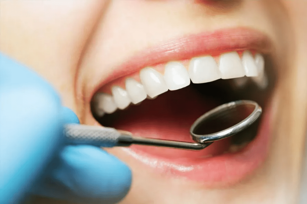 Dentist using a small mirror to look for signs of oral cancer