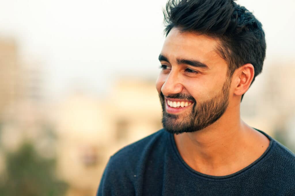 Smiling man with bright white smile from teeth whitening in Spring, TX