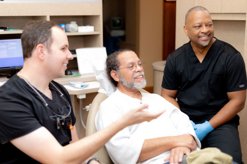 Dr. Reagan Smith and his staff discussing treatment options with a patient in Spring, TX